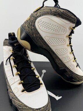 Jordan 9 Retro Pollito sneakers in white with black and gold herringbone pattern